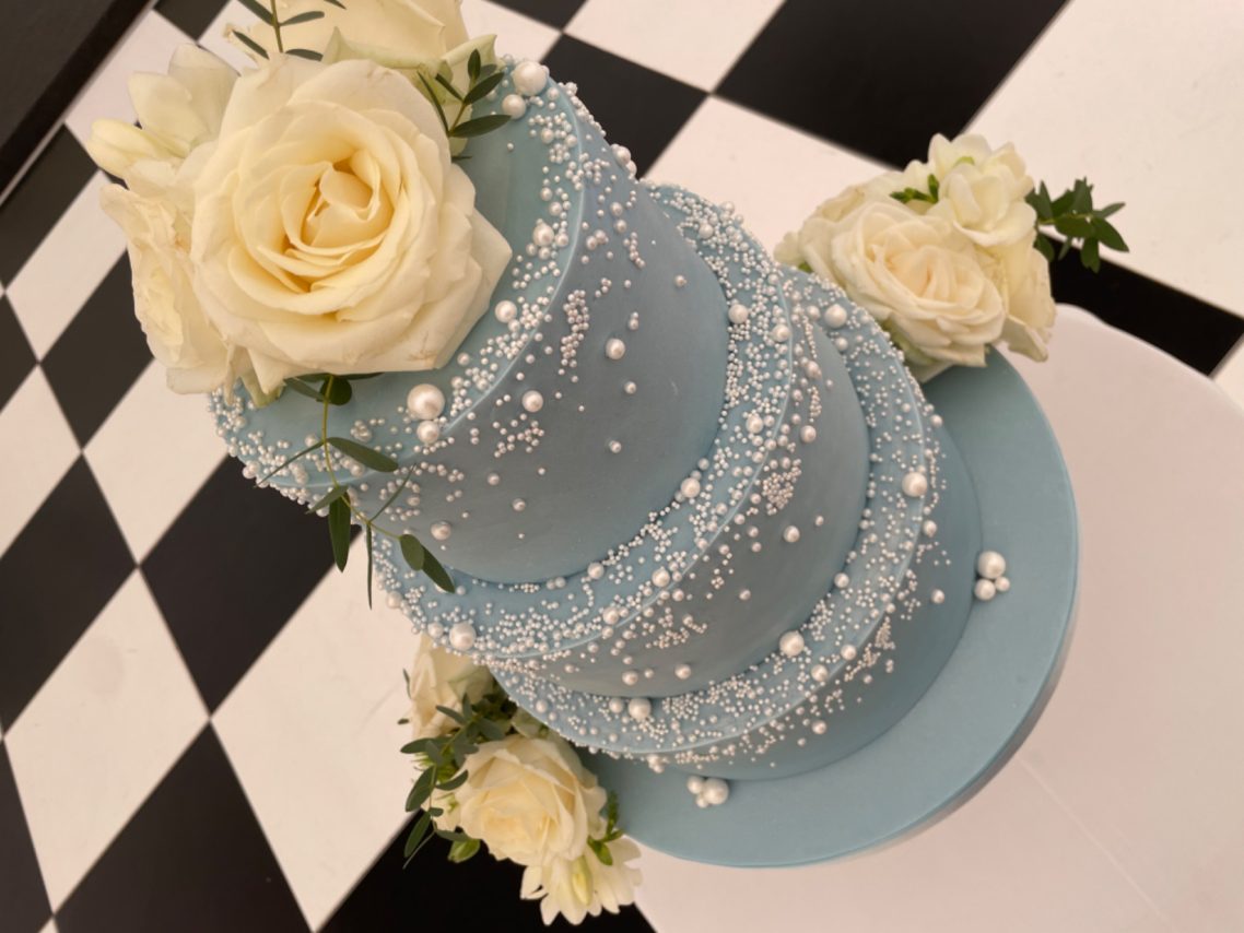 Stunningly elegant cascading pearl decorated baby blue three tier wedding cake Stunningly elegant cascading pearl decorated baby blue three tier wedding cake